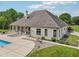 Rear exterior view of home featuring a patio, well-manicured lawn, and swimming pool at 2825 S State Road 267, Plainfield, IN 46168