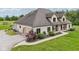 Charming brick home with a well-manicured lawn, landscape, attached garage, and inviting front porch at 2825 S State Road 267, Plainfield, IN 46168