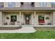Inviting covered front porch with seating and hanging plants at 2825 S State Road 267, Plainfield, IN 46168