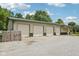Spacious, four-car detached garage featuring multiple doors and a metal roof in a verdant, tree-lined setting at 2825 S State Road 267, Plainfield, IN 46168