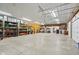 Expansive garage space with shelving and concrete floor, offering a versatile area for various activities and storage at 2825 S State Road 267, Plainfield, IN 46168