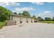 Large, detached four-car garage with ample parking space, set against a backdrop of a lush, green lawn at 2825 S State Road 267, Plainfield, IN 46168