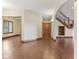 Open hallway with hardwood floors leads to the stairs and another room at 2825 S State Road 267, Plainfield, IN 46168