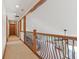 Upstairs hallway features decorative iron railing and neutral carpet at 2825 S State Road 267, Plainfield, IN 46168
