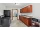Functional kitchen with wooden cabinets, sink, and concrete flooring at 2825 S State Road 267, Plainfield, IN 46168