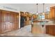 Farmhouse kitchen featuring custom cabinets, granite countertops, island, and tile flooring at 2825 S State Road 267, Plainfield, IN 46168