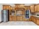 Spacious kitchen with granite counters, stainless appliances, and ample custom wood cabinetry at 2825 S State Road 267, Plainfield, IN 46168