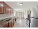 Well lit kitchen with wooden cabinetry, stainless appliances, and concrete flooring at 2825 S State Road 267, Plainfield, IN 46168