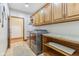 Laundry room with upper cabinets, side table, and included washer and dryer at 2825 S State Road 267, Plainfield, IN 46168