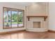 Sunlit living area showcasing a brick fireplace and large windows with scenic views at 2825 S State Road 267, Plainfield, IN 46168