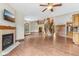 Open-concept living space featuring hardwood floors, a fireplace, and staircase to upper level at 2825 S State Road 267, Plainfield, IN 46168