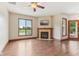 Bright living room featuring a fireplace, ceiling fan, and a view of the pool outside the window at 2825 S State Road 267, Plainfield, IN 46168