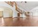 Spacious living room with hardwood floors, high ceilings, staircase, and arched doorways at 2825 S State Road 267, Plainfield, IN 46168