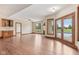 Open-concept living area featuring hardwood floors, fireplace, and access to the outdoor pool at 2825 S State Road 267, Plainfield, IN 46168