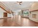 Bright and open living room featuring a fireplace and a staircase with wood railing at 2825 S State Road 267, Plainfield, IN 46168
