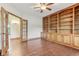 Office features custom built-in shelving, hardwood floors, and a ceiling fan at 2825 S State Road 267, Plainfield, IN 46168