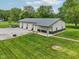 Aerial view of a large outbuilding with multiple bays, set in a well-manicured lawn at 2825 S State Road 267, Plainfield, IN 46168