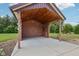 Covered outdoor bar area with wood ceiling and string lights next to a grassy backyard at 2825 S State Road 267, Plainfield, IN 46168