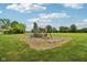 Outdoor playground with a slide and swings set in a spacious, grassy yard, ideal for Gathering fun at 2825 S State Road 267, Plainfield, IN 46168