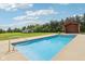 An inviting in-ground pool with a pool house and large garage in the background at 2825 S State Road 267, Plainfield, IN 46168