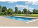A full shot of the rectangular pool with a pool cover, surrounded by a large, manicured lawn at 2825 S State Road 267, Plainfield, IN 46168
