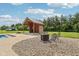 Backyard pool house with a seating area and fire pit, perfect for outdoor entertaining at 2825 S State Road 267, Plainfield, IN 46168