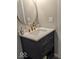 Stylish bathroom vanity features navy blue cabinets, gold hardware, and a round mirror at 2968 N Arsenal Ave, Indianapolis, IN 46218
