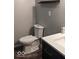 Modern bathroom includes a toilet, floating shelf, and navy vanity with white countertop at 2968 N Arsenal Ave, Indianapolis, IN 46218