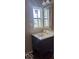 Bathroom featuring a dark vanity with light countertops and a window at 2968 N Arsenal Ave, Indianapolis, IN 46218