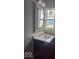 Bathroom featuring a vanity and mirror with natural light at 2968 N Arsenal Ave, Indianapolis, IN 46218