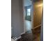 Hallway leading to a bedroom with hardwood floors and natural light at 2968 N Arsenal Ave, Indianapolis, IN 46218
