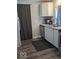 Modern kitchen with stainless steel appliances, dark wood floors and grey cabinets at 2968 N Arsenal Ave, Indianapolis, IN 46218