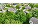 Overhead view of a residential neighborhood showcasing lush trees and beautifully maintained homes with green lawns at 3251 Amber Way, Bargersville, IN 46106
