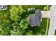 Bird's-eye view of a home with a dark roof surrounded by a green yard, trees, and an outdoor seating area at 3251 Amber Way, Bargersville, IN 46106