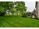 Sprawling green backyard with mature trees, patio furniture, and a hammock at 3251 Amber Way, Bargersville, IN 46106