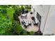 Relaxing backyard patio featuring a seating area, dining table, grill, and beautifully landscaped garden at 3251 Amber Way, Bargersville, IN 46106