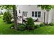 Charming patio area featuring outdoor seating, a cozy fire pit, and beautifully landscaped greenery and flowerbeds at 3251 Amber Way, Bargersville, IN 46106