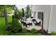 Serene outdoor patio area complete with comfortable furniture, a grill, and lush landscaping for ultimate relaxation at 3251 Amber Way, Bargersville, IN 46106