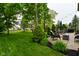 Landscaped backyard featuring patio furniture, lush grass, and mature trees at 3251 Amber Way, Bargersville, IN 46106