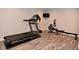 Home gym with a treadmill, rowing machine, and mounted TV at 3251 Amber Way, Bargersville, IN 46106