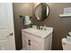 Stylish bathroom features a white vanity with a marble countertop and a round mirror at 3251 Amber Way, Bargersville, IN 46106