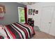 Cozy bedroom featuring a striped bedspread, sports decor, and a bright window view at 3251 Amber Way, Bargersville, IN 46106