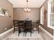 A dining room with a wooden table, chairs, overhead lighting, and wood-style flooring at 3251 Amber Way, Bargersville, IN 46106