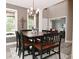An open dining room with table, chairs, an overhead chandelier, and view of living room at 3251 Amber Way, Bargersville, IN 46106