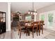 Open-concept dining room with contemporary lighting, wood floors, and easy access to the living room at 3251 Amber Way, Bargersville, IN 46106