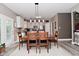 Charming dining area with modern lighting fixture, wooden table set, and easy access to both kitchen and living spaces at 3251 Amber Way, Bargersville, IN 46106