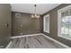 Dining room showcases a modern chandelier, hardwood floors, and natural light at 3251 Amber Way, Bargersville, IN 46106