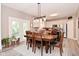 Inviting dining area featuring stylish decor, wood table, and a seamless transition to the bright kitchen at 3251 Amber Way, Bargersville, IN 46106