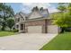 Side view of a brick home with a spacious driveway and three car garage at 3251 Amber Way, Bargersville, IN 46106