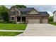 Charming two-story brick and vinyl home with a well-manicured lawn and a spacious three-car garage at 3251 Amber Way, Bargersville, IN 46106
